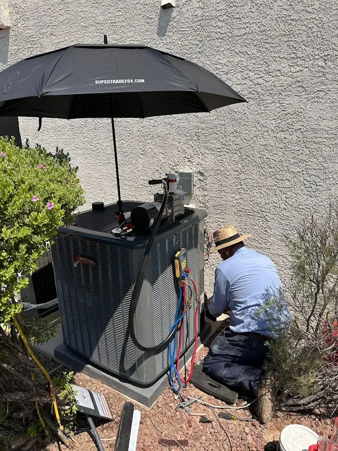 HVAC technician performing outdoor AC maintenance in Yosemite Lakes