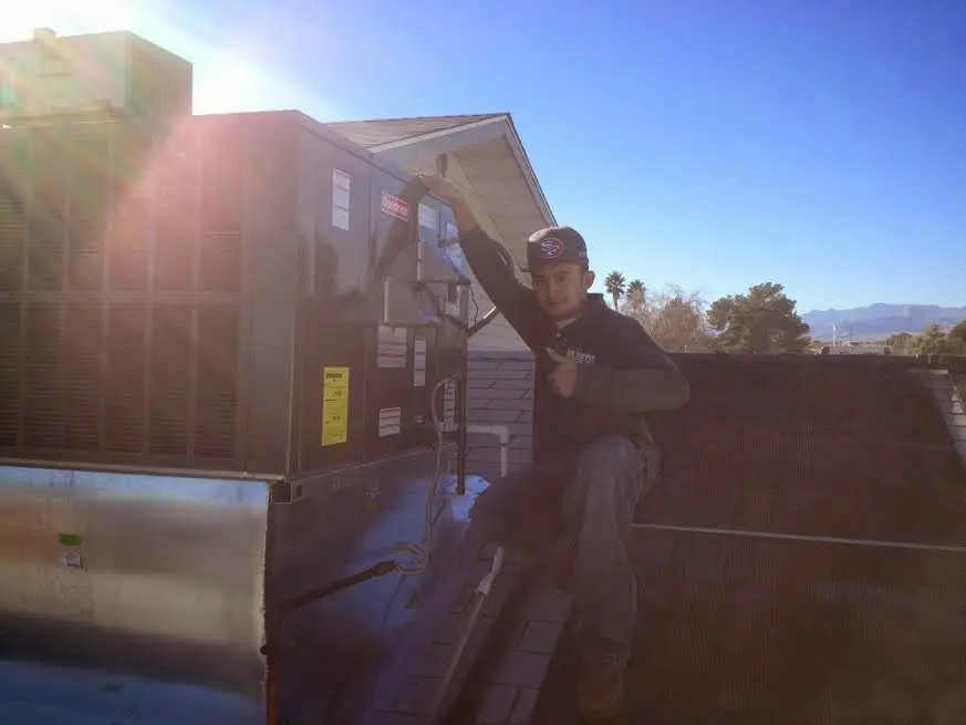 HVAC technician performing HVAC Inspection on a rooftop unit in Yosemite Lakes